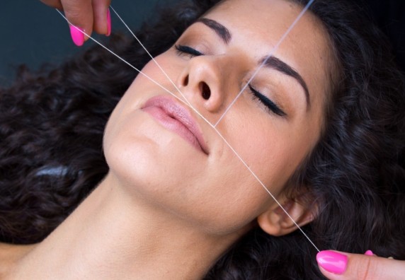 attractive-woman-in-beauty-salon-on-facial-hair-removal-threading-procedure